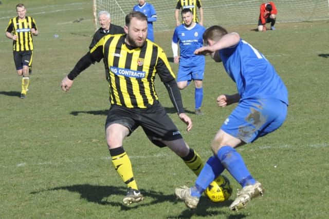 Bexhill Rovers and Catsfield tussle for possession.