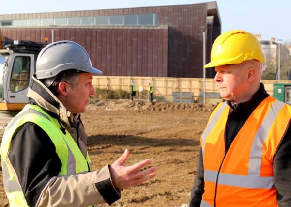 Councillor Kevin Jenkins, right, talks to Roffey Homes Bayside project manager Simon Snow at the former Aquarena site