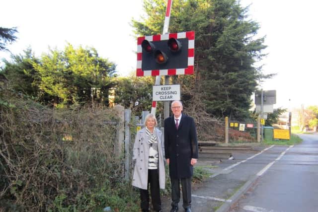 Resident Marilyn Phipps with Nick Gibb at the Toddington Lane level crossing