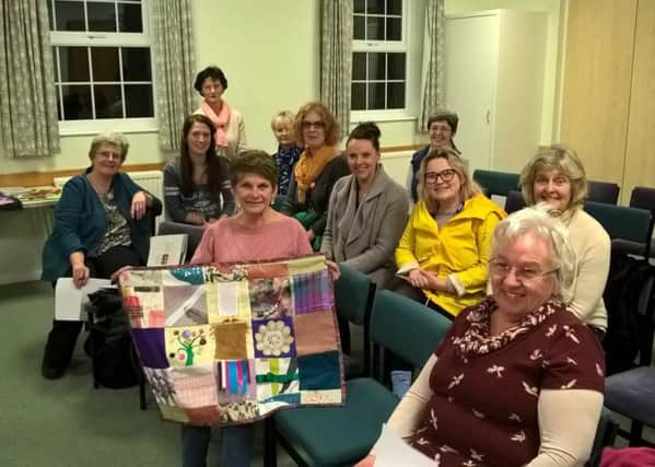 Left to right front row: Jan White, textile designer leading the group, and Irene Balls, chairman of HHTA, with members of the community
