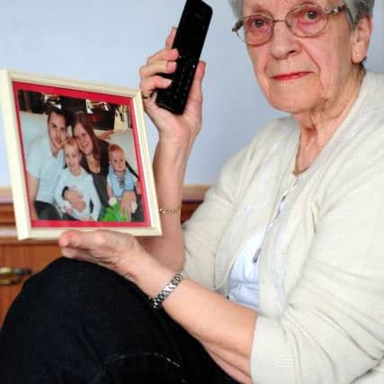 Jean Whittington from Nelson Close, Sompting, holding a picture of her granddaughter, who got the phone fixed. Picture: Kate Shemilt