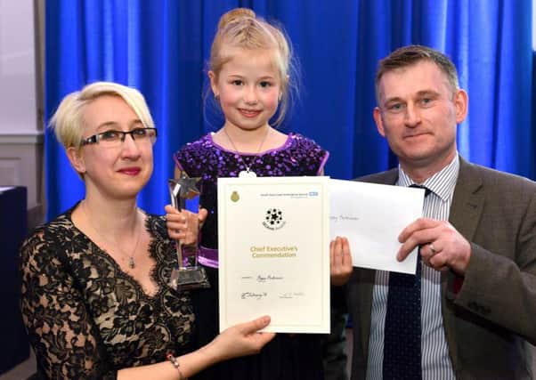 Poppy Parkinson receives her public commendation alongside her mother Ruth Botley