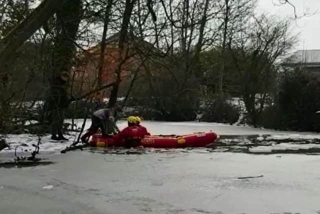 Fire crews used an inflatable raft to get the two boys to safety. Picture: Amy Latter