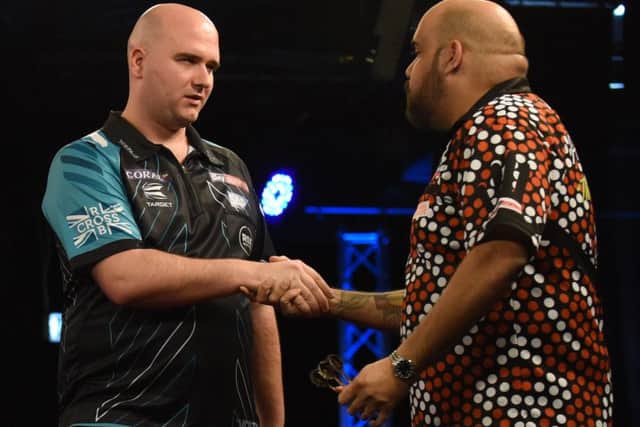 Rob Cross shakes hands with opponent Kyle Anderson at the end of their fourth round match. Picture courtesy Chris Dean/PDC