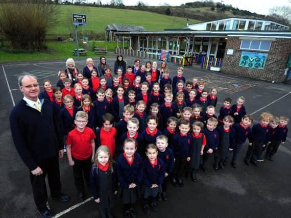 Headteacher Christopher Todd (front left) with the staff and children of Singleton CE Primary School