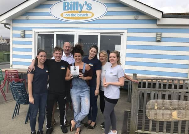 Billy's On The Beach staff with an award