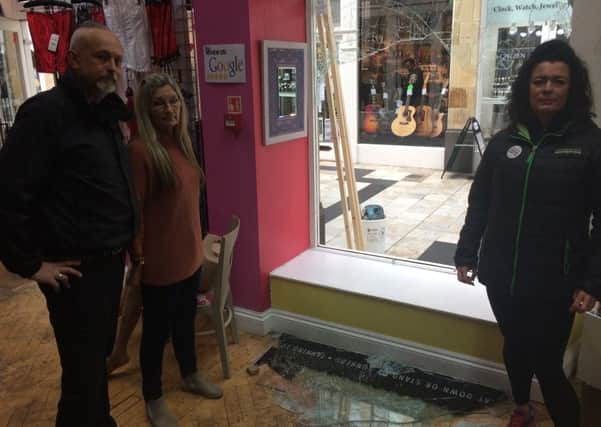 Manager Kevin Wiles, sales assistant Gina Wright and owner Sarah Jane Orchin by the broken window