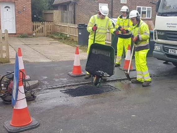 Highways crews fixing a pothole in Haywards Heath today (March 9)