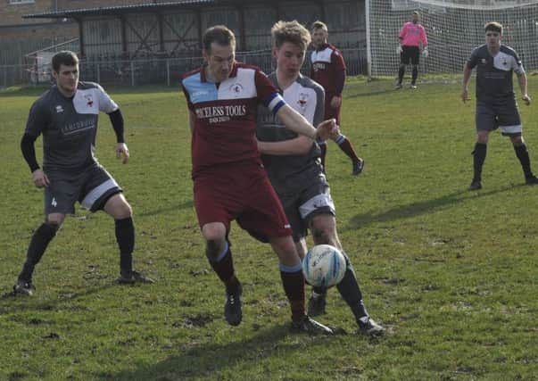 Little Common forward Lewis Hole holds off a Wick opponent. Pictures by Simon Newstead