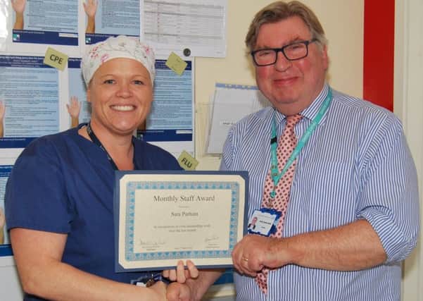 Deputy Lead Practitioner and Theatre Sister, Sara Parham, was presented with her Trust staff award by Trust Chairman, David Clayton-Smith. SUS-180313-122520001