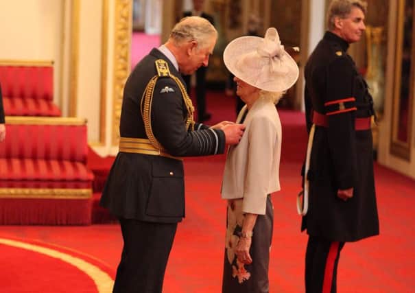 Foster mum Babs Bower receives the MBE from Prince Charles SUS-181203-123211001