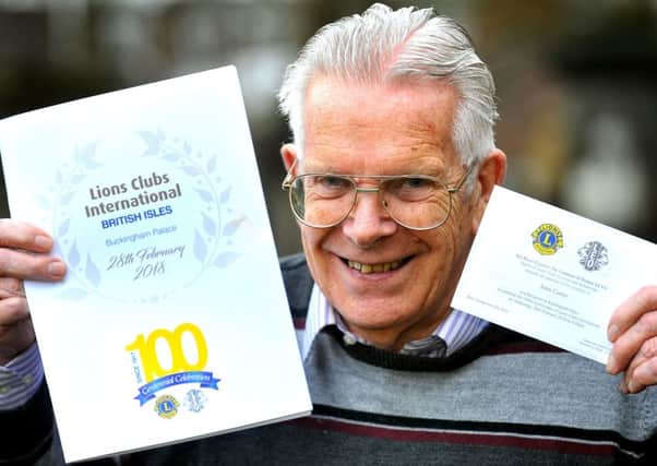 John Carter, president of Burgess Hill District Lions Club holding the Buckingham Palace invitation. Picture: Steve Robards