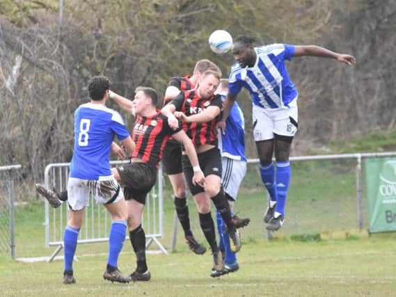 Melford Simpson out-jumps the Saltdean defence. Saltdean United v Haywards Heath Town. Picture by Grahame Lehkyj