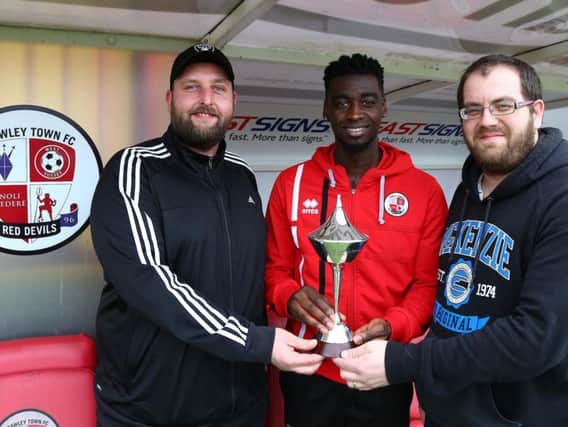 Enzio Boldewijn with two fans who won competition to present the trophy, Craig Johnston (left) and Mick Murrell