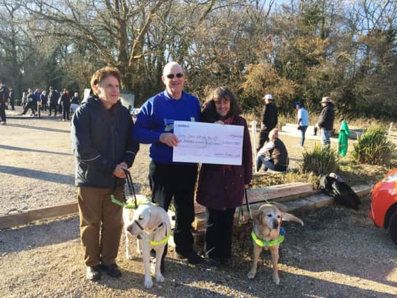 Worthing Petanque Club treasurer Keith Rutter presents the cheque to Miriam and John for Guide Dogs for the Blind