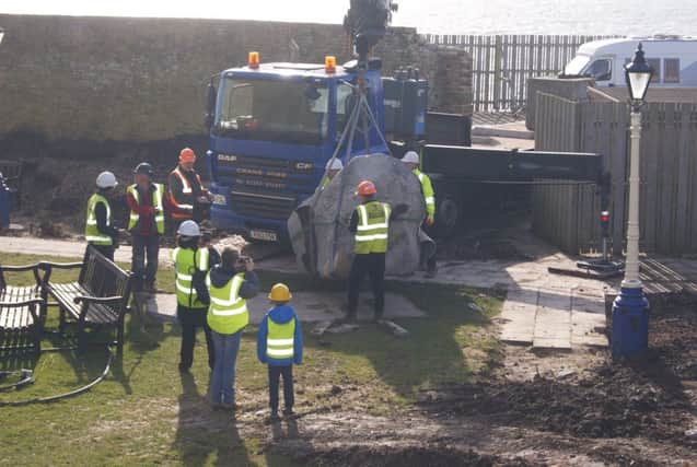 Memorial being moved into place. Photo by Peter Austin. SUS-180314-120941001