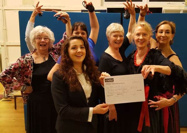 Students from Helenas Flamenco School present the cheque