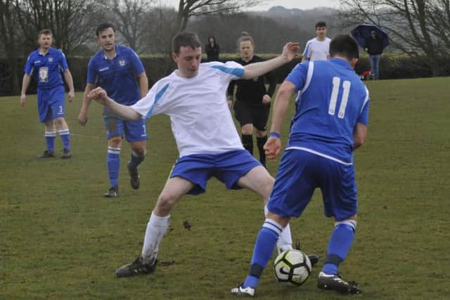 Sidley United and Northiam 75 compete for possession.
