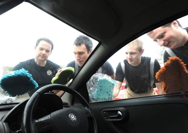 East Wittering firecrew douse their sponges for the fundraising carwash event in a previous year