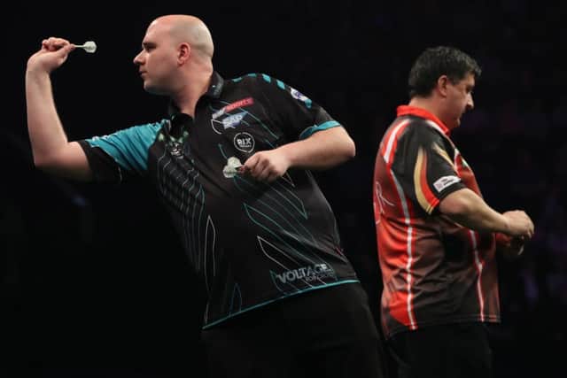 Rob Cross at the oche against Mensur Suljovic. Picture courtesy Lawrence Lustig/PDC