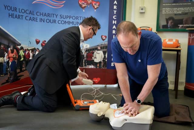 L-R: David Jones (Area Sales Manager Cardiac Science), and Steve Morris, whose life was saved by an AED and is now a qualified community resuscitation trainer. SUS-180316-130241001