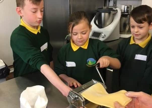The children try their hand at making pasta