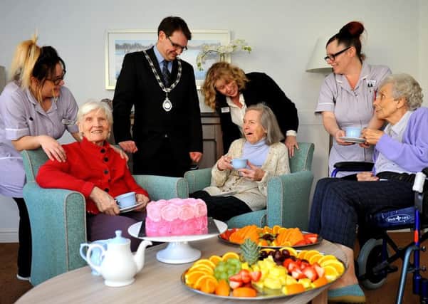 Rustington Parish Council chairman Jamie Bennett joins manager Nikki Burke, staff and residents to celebrate the launch of the community cafe. Picture: Steve Robards SR1807261