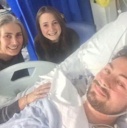 Will with his mum and sister while in hospital