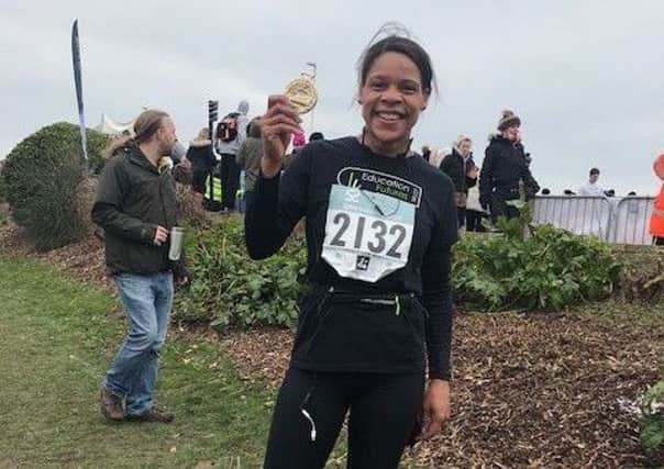 Tracey Kane with her medal after completing the Hastings Half Marathon 2018 SUS-180328-132822001