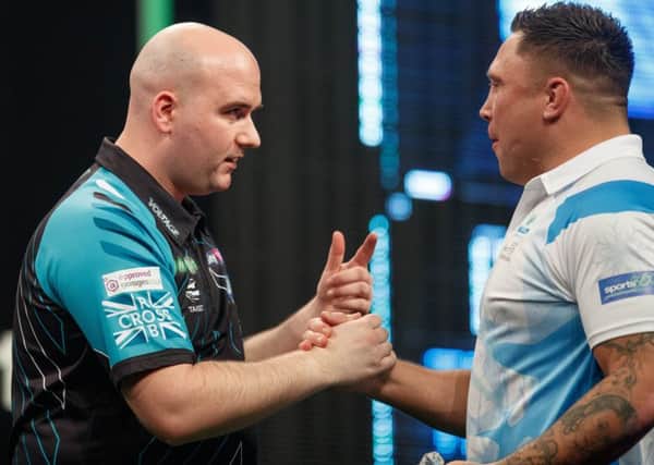 Rob Cross shakes hands with opponent Gerwyn Price at The SSE Hydro in Glasgow. Picture courtesy Steve Welsh/PDC