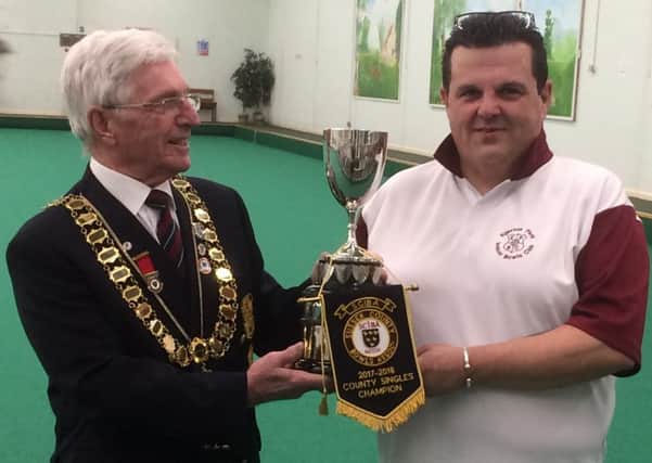 Rob Morphett receives his prizes for winning the Sussex County Indoor Bowls Association singles championship from Sussex County Indoor Bowls Association president Barry Baillie.