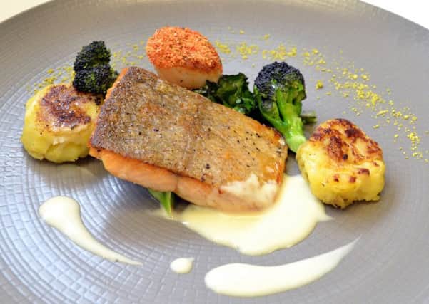 Pan-fried trout fillet and scallop with passion fruit fish veloutÃ© and rustic potatoes