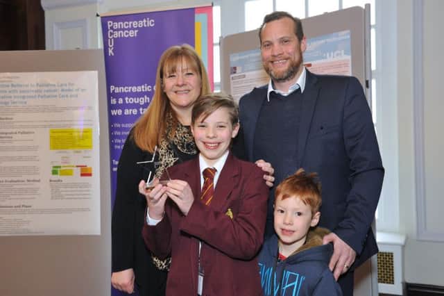 Alex Webb with his award, parents and little brother Ben