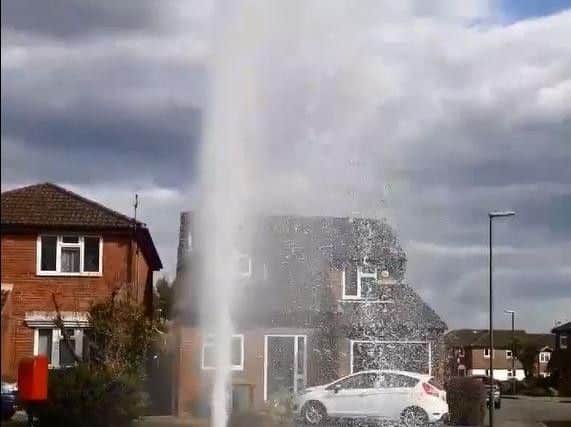 Water explodes from pavement in Cedar Drive. Photo by Julia Mattock