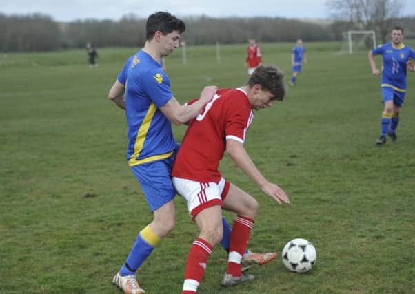 Bexhill Town and Rye Town tussle for possession during their tight cup clash at Bexhill Road. Picture by Simon Newstead
