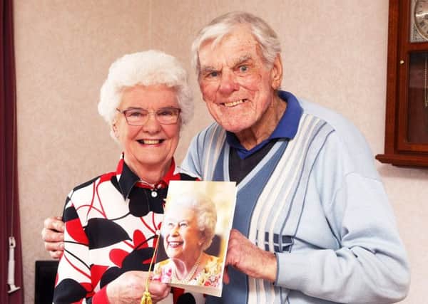 Janette and Colin Short with the card from the Queen for their 60th wedding anniversary. Photo by Derek Martin DM1833739a