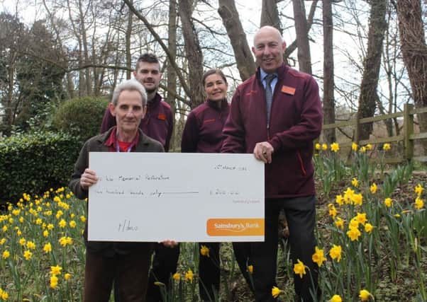 Horsham District Council's parks and countryside officer John Marder receiving the cheque from Sainsbury's SUS-180328-170706001