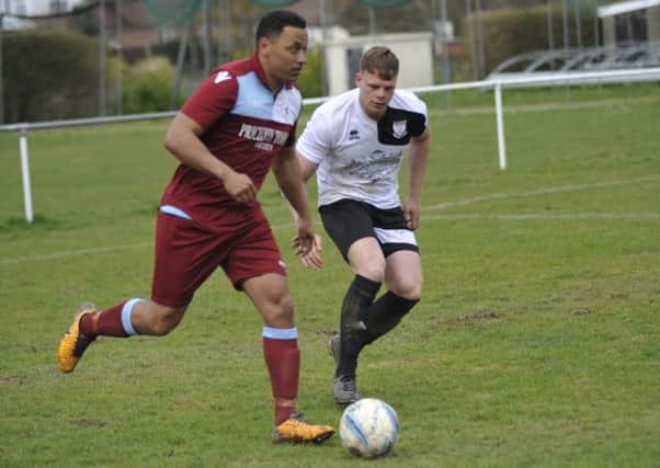 Little Common midfielder Wes Tate is closely watched by Bexhill United defender Lewis McGuigan. Pictures by Simon Newstead