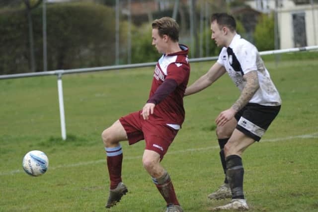 Sam Ellis, scorer of Little Common's second goal, tries to bring the ball under control with Bexhill United midfielder Gordon Cuddington in close attendance.