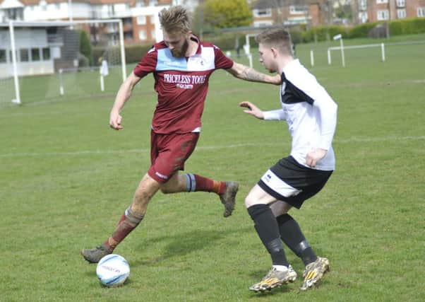 Little Common full-back Ryan Paul is closed down by Bexhill United wide player Corey Wheeler. Picture by Simon Newstead