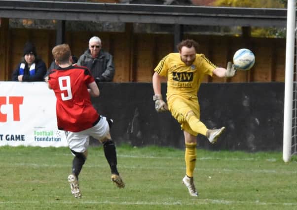 Loxwood goalkeeper Sam Smith clears the ball against Haywards Heath on Saturday. Picture by Grahame Lehkyj