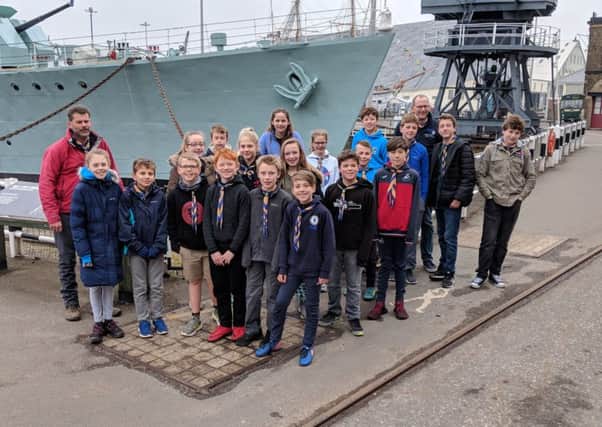 Some of the Sullington and Storrington Scouts pictured by the bows of HMS Cavalier SUS-180404-124716001