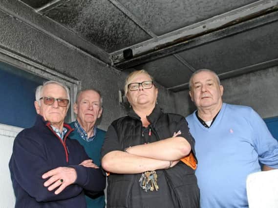 (Left to right): Derek Fish, club secretary, David Beatty, chairman, Annette Humphrey, club administrator, and councillor Colin Cates, in front of the smoke damaged walls and ceiling. Photo by Derek Martin Photography