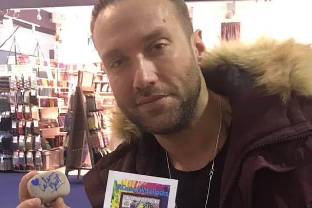 Television personality Calum Best with his signed pebble for the #CancerWiseRocks campaign