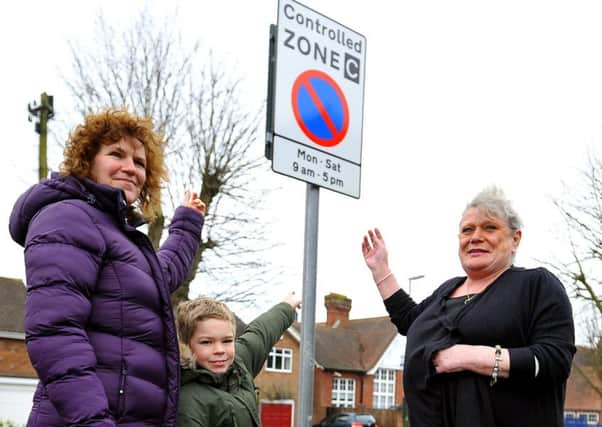 Ruth Dalton and neighbours Tricia Evans and her son Callum  who are unhappy about the new street signs near their homes. Photo: Steve Robards