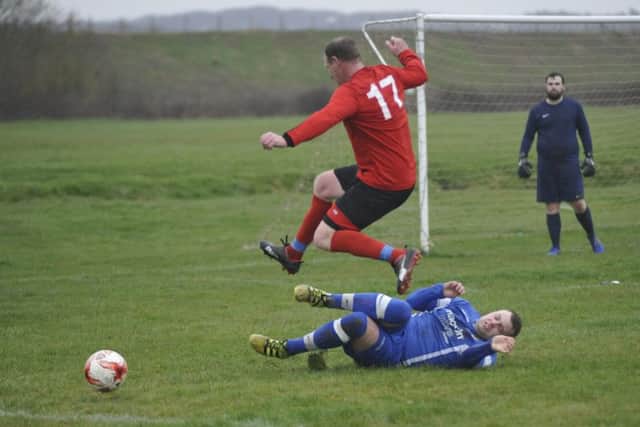A Sedlescombe Rangers II defender makes a sliding tackle against Bexhill AAC.