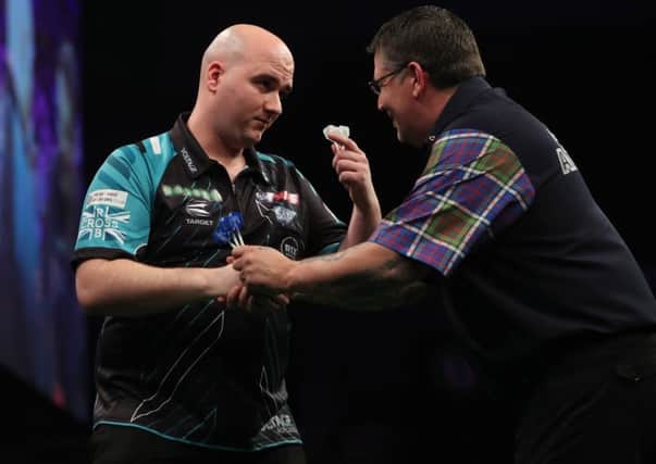 Rob Cross shakes hands with Gary Anderson at the end of the match. Picture courtesy Lawrence Lustig/PDC