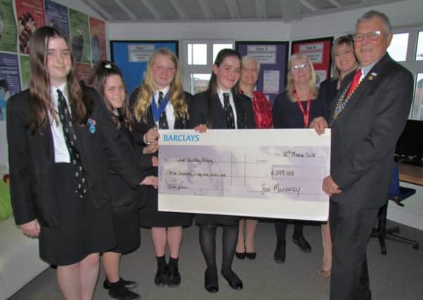 Emma, Kiera, Chloe and Erin present a cheque to club president Jeremy Flaskett. In the background are Carol Flaskett, Rotarian Sue Virgo and Karen Jefford, the school community and enterprise manager