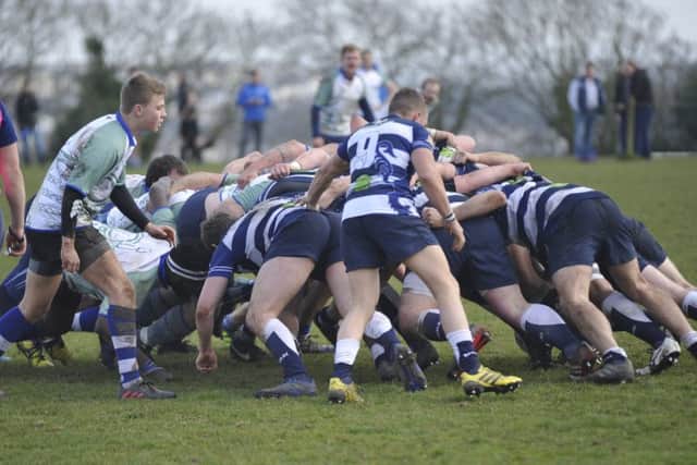 The two sets of forwards battle for supremacy at a scrum.