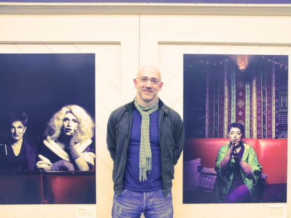 Photographer James Bellorini at his Fringe exhibition at Brighton station (Photograph: Peter Williams)